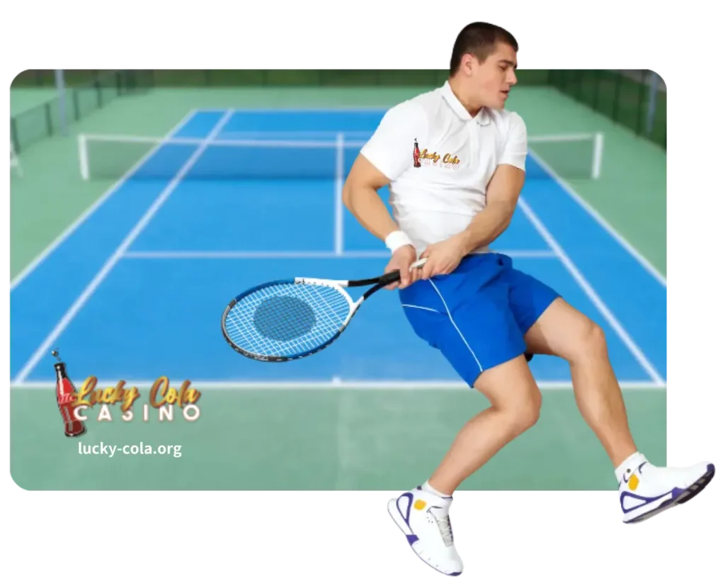 A male tennis player in a white outfit preparing to hit a forehand shot on a blue hard court.